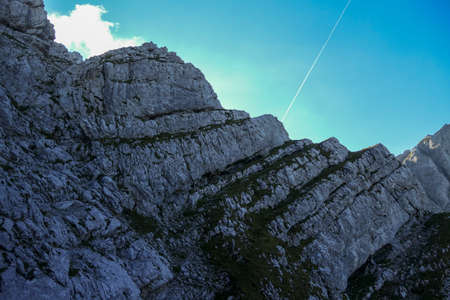 A panoramic view on Alpine slopes in Austria. There are sharp ans steep mountains and high peaks...