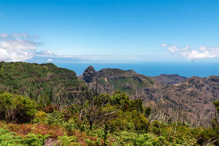 Scenic view on massive volcanic rock formation Roque de Agando in Garajonay National Park on La...