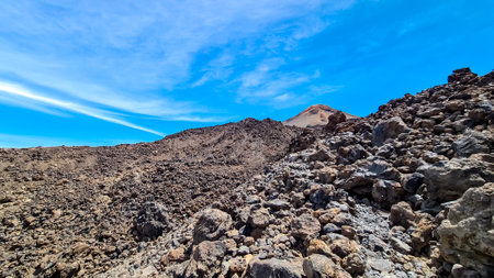 Hiking trail over volcanic desert terrain leading to summit of volcano Pico del Teide from Pico Viejo, Mount Teide National Park, Tenerife, Canary Islands, Spain, Europe. Solidified lava, ash, pumiceの写真素材