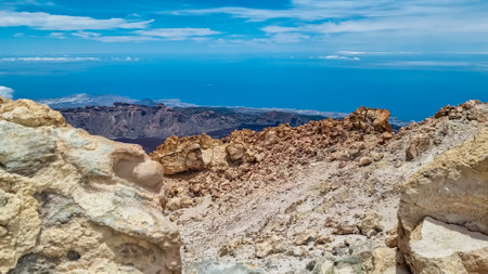 Panoramic view on volcanic desert terrain near summit of volcano Pico del Teide, Mount Teide National Park, Tenerife, Canary Islands, Spain, Europe. Solidified lava, ash, pumice. Clouds accumulatingの写真素材