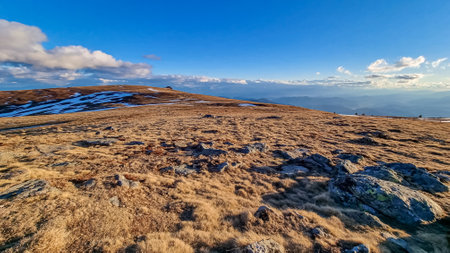 Scenic morning view after sunrise on summit cross of mountain peak Grosser Sauofen, Saualpe, Lavanttal Alps, Carinthia, Austria, Europe. Hiking trail in Wolfsberg. Karawanks mountains in the backの写真素材