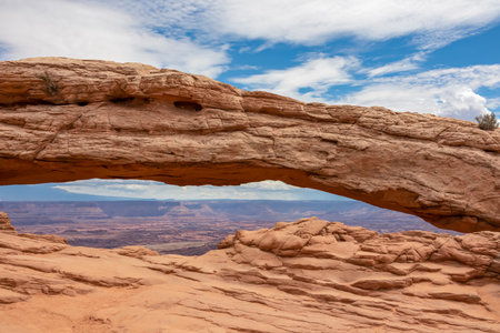 Scenic view through Mesa Arch near Moab, Canyonlands National Park, San Juan County, Southern Utah, USA. Looking at natural pothole arch rock formation on the eastern edge of Island in the Sky Mesaの写真素材