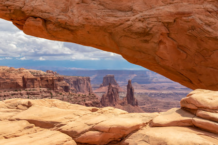 Scenic view through Mesa Arch near Moab, Canyonlands National Park, San Juan County, Southern Utah, USA. Looking at natural pothole arch rock formation on the eastern edge of Island in the Sky Mesaの写真素材