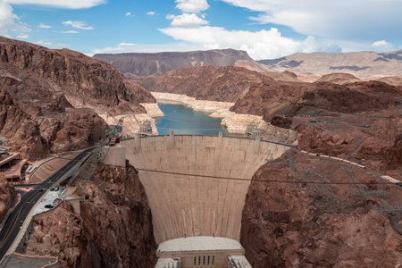 Scenic view of wall of Hoover Dam filled with turquoise water surrounded by River mountain range, Nevada Arizona, USA. Renewable energy plant in Lake Mead National Recreation Area near Las Vegasの写真素材