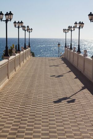walkway to the sea with lamp postsの写真素材