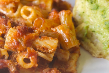 bolognese pasta melt with garlic bread closeupの写真素材