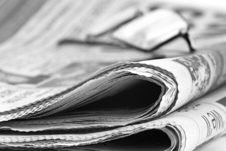 Newspaperfolded up with specsの写真素材