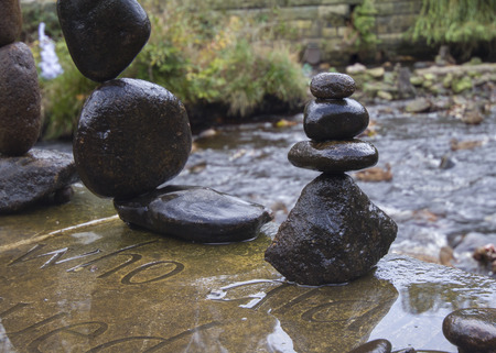 Balanced stones stack next to a stream