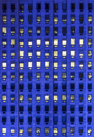 exterior blue light on windows on a hight office building