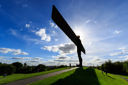 View of the Angel of the North statue with blue sky and white clouds.の写真素材