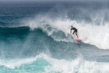 Man surfing on a red surf board