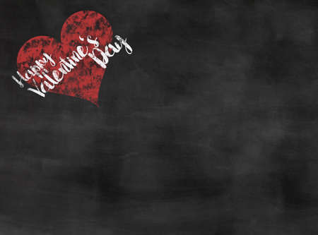 words happy Valentine's Day written on blackboard with red heartの写真素材