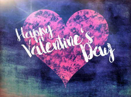 words happy valentines day written on blackboard with red heartの写真素材