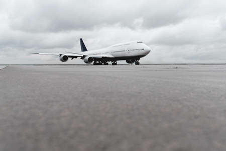 low angle view of big airliner passenger jet plane on taxiway or runwayの写真素材