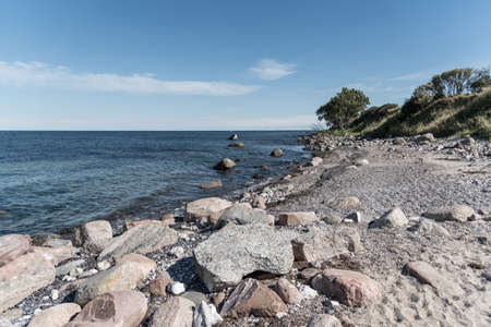 natural beach with rocks at baltic sea coast in Germanyの写真素材