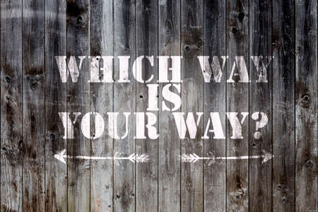 weathered timber wood planks background with words which way is your way and arrows pointing in two directionsの写真素材