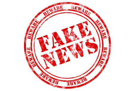 rubber stamp print in red with words fake news on white backgroundの写真素材