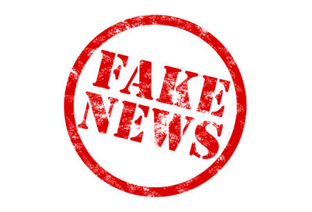 rubber stamp print in red with words fake news on white backgroundの写真素材