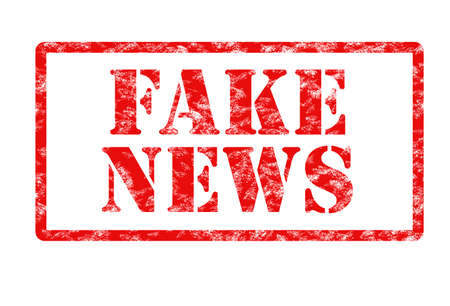 rubber stamp print in red with words fake news on white backgroundの写真素材