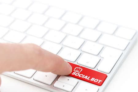 finger pressing a red key labeled SOCIAL BOT with robot symbol on a computer keyboard concept の写真素材
