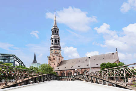 low angle shot of Sankt Katharinen church in Hamburg, Germany as seen from opposite side of Zollkanal channelの写真素材