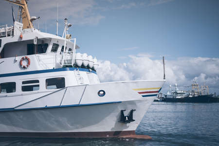 excursion boat in a harbor on the Island of Sylt, Germany under blue skyの写真素材