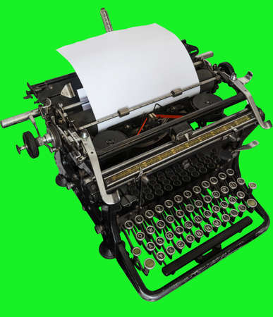 diagonal view of vintage manual typewriter isolated on green background templateの写真素材