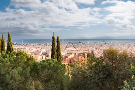 high angle view of Barcelona cityscape against sea and sky on sunny dayの写真素材