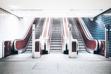 symmetric shot of three escalators in underground subway stationの写真素材