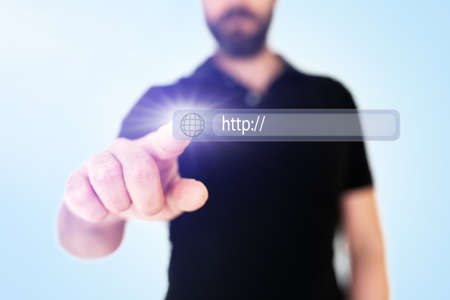 businessman touching browser address bar with globe icon on translucent interface, digital composite