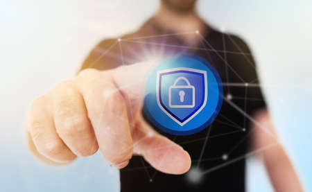 network security concept with businessman touching padlock icon on translucent touch screen, digital compositeの写真素材