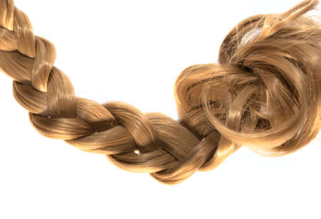 blond plait strand of blond hair on white backgroundの写真素材