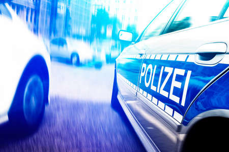 close-up shot of police car with flashing emergency lights on motion blurred urban street