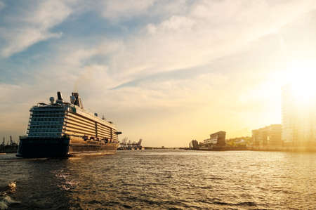large cruise ship on Elbe river in golden sunset sunlight