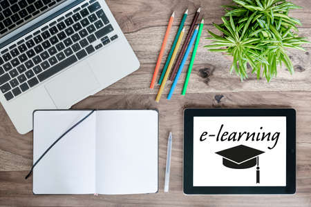 online education e-learning concept with laptop computer, tablet and notepad on wooden desk