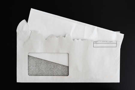 top view of folded letter in torn open envelope on black backgroundの写真素材