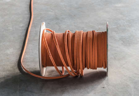 large roll of communications cable on concrete floor
