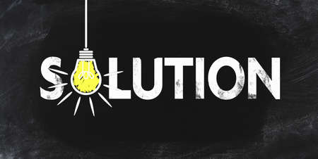 word SOLUTION an blackboard  with blowing light bulb symbolizing an idea
