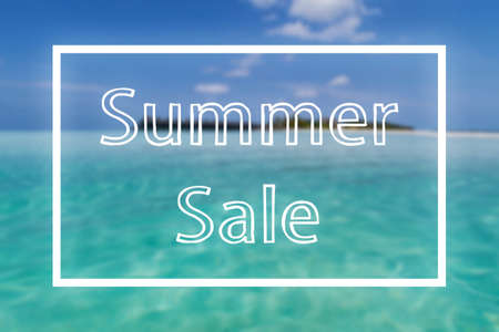 framed text SUMMER SALE against blurred tropical island and turquiose seaの写真素材