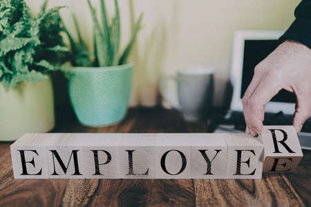 transition from employee to employer, business or entrepreneur concept with wooden blocksの写真素材