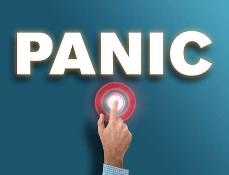 male hand pushing red glowing panic button, danger and hysteria reaction conceptの写真素材