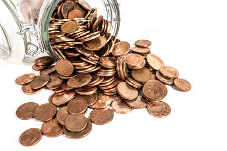 small change euro cent coins pouring out of glass jar isolated on white background, withdrawal of...