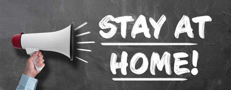 man with megaphone shouting STAY AT HOME, social distancing due to corona virus pandemic conceptの写真素材