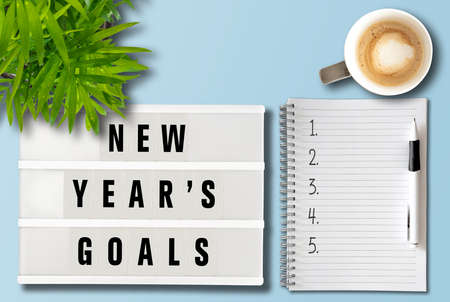 new years goals or resolutions concept with top view of lightbox and notepad on deskの写真素材