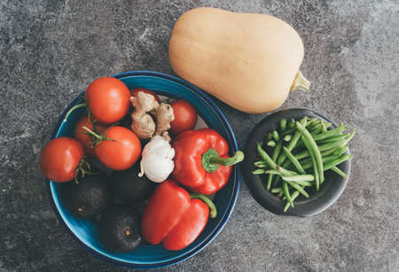 directly above shot of healthy vegetables in bowls on stone kitchen counterの写真素材