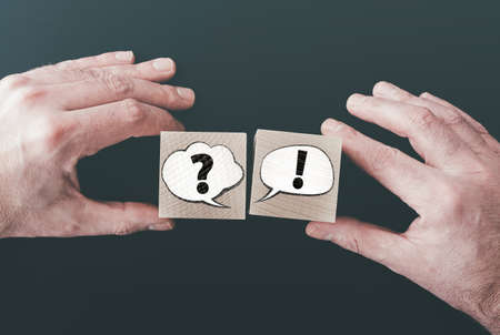 question and answer or communication concept with speech bubbles on wooden blocksの写真素材