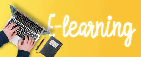 e-learning and online education concept, top view of person using laptop computer on colorful background with text e-learningの写真素材