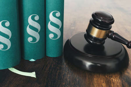 close-up of judges gavel and law books on rustic wooden tableの写真素材
