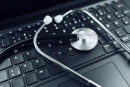 close-up high angle view of stethoscope on laptop computer keyboardの写真素材