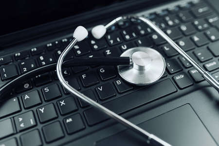 close-up high angle view of stethoscope on laptop computer keyboard